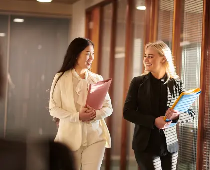 Two workers at a law firm discussing document storage