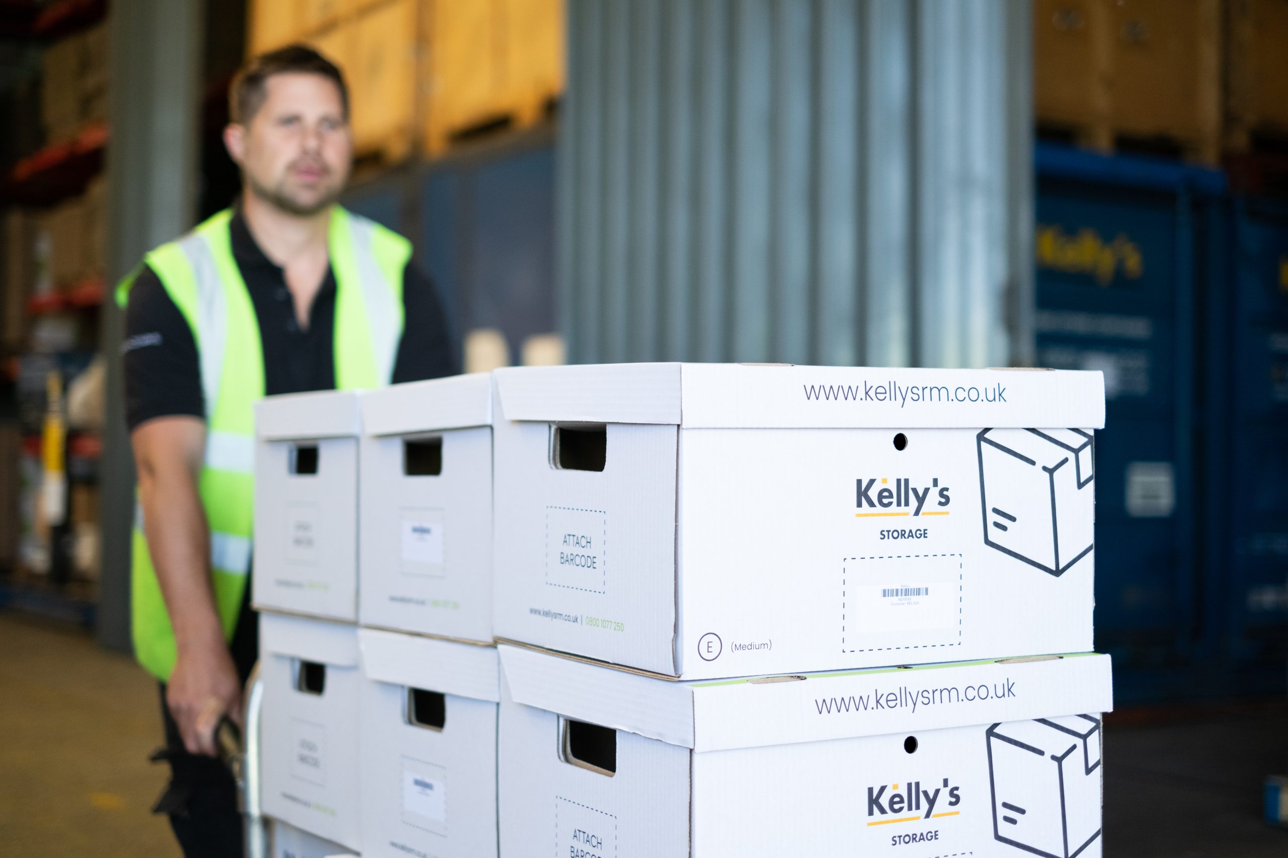 Picture of a Document Storage worker pushing a trolley full of stacked document storage boxes