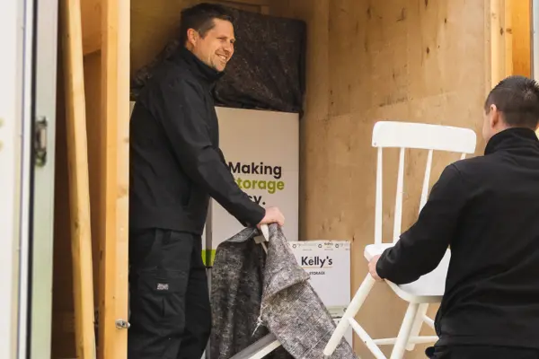 Office furniture being packed into a van
